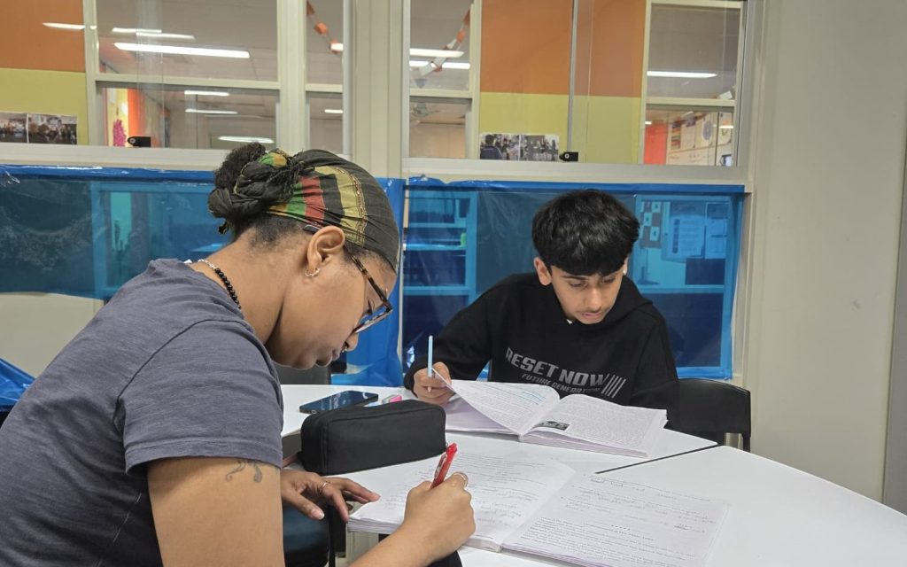 Older student working with a tutor on VCE homework